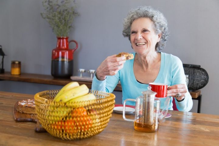 Woman eating a healthy balanced meal to support bladder health and manage urinary leakage.