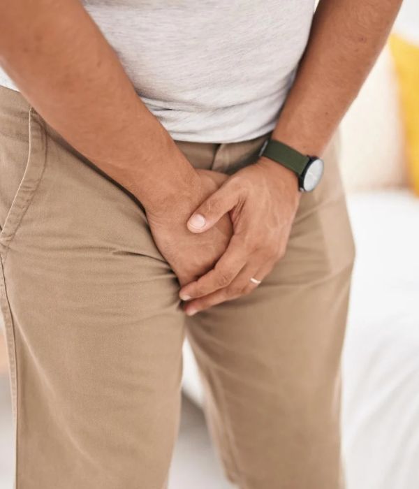Man experiencing a sudden urge to urinate due to urge incontinence.