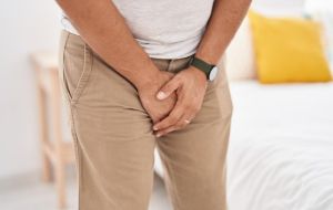 Man experiencing sudden urinary urgency associated with urge incontinence