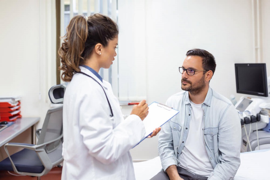 man consulting doctor about possible bladder infection