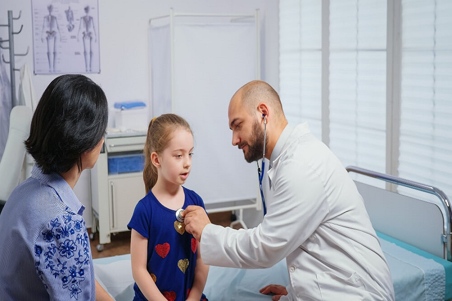 doctor examining child about possible bladder infection
