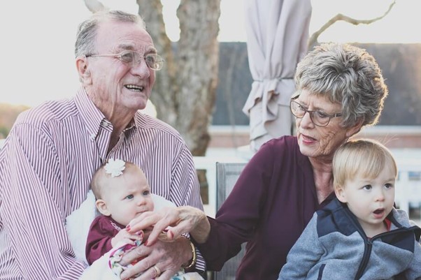 elderly male and female with grandchildren