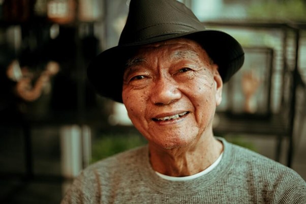 elderly male in hat smiling