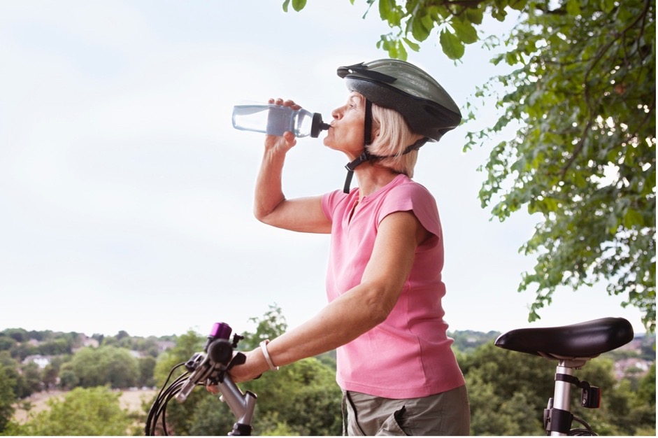 Woman drinking water on a bike