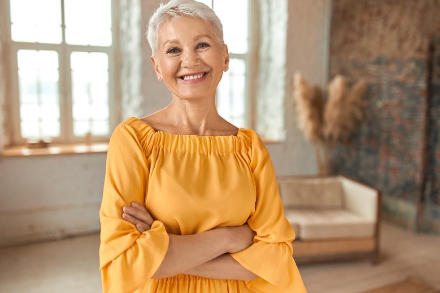 Women with arms crossed smiling after choosing the best incontinence product for her 